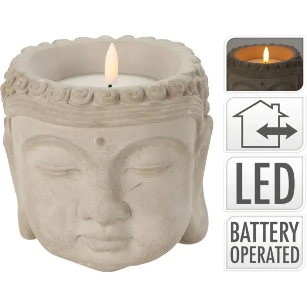Stone Buddha head candle holder with a lit LED candle on the crown, decorative desk sculpture for ambience