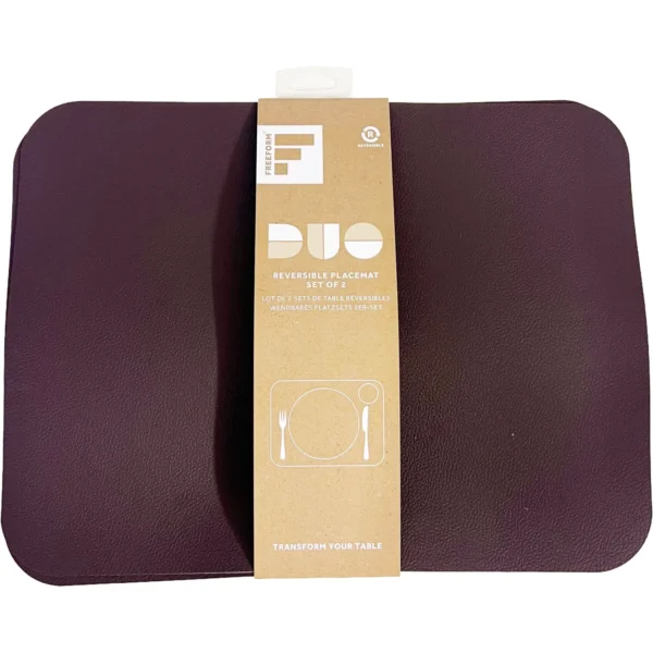 Two burgundy, leather-textured placemats in a set of two, wrapped with a brown paper label reading DUO and Transform Your Table