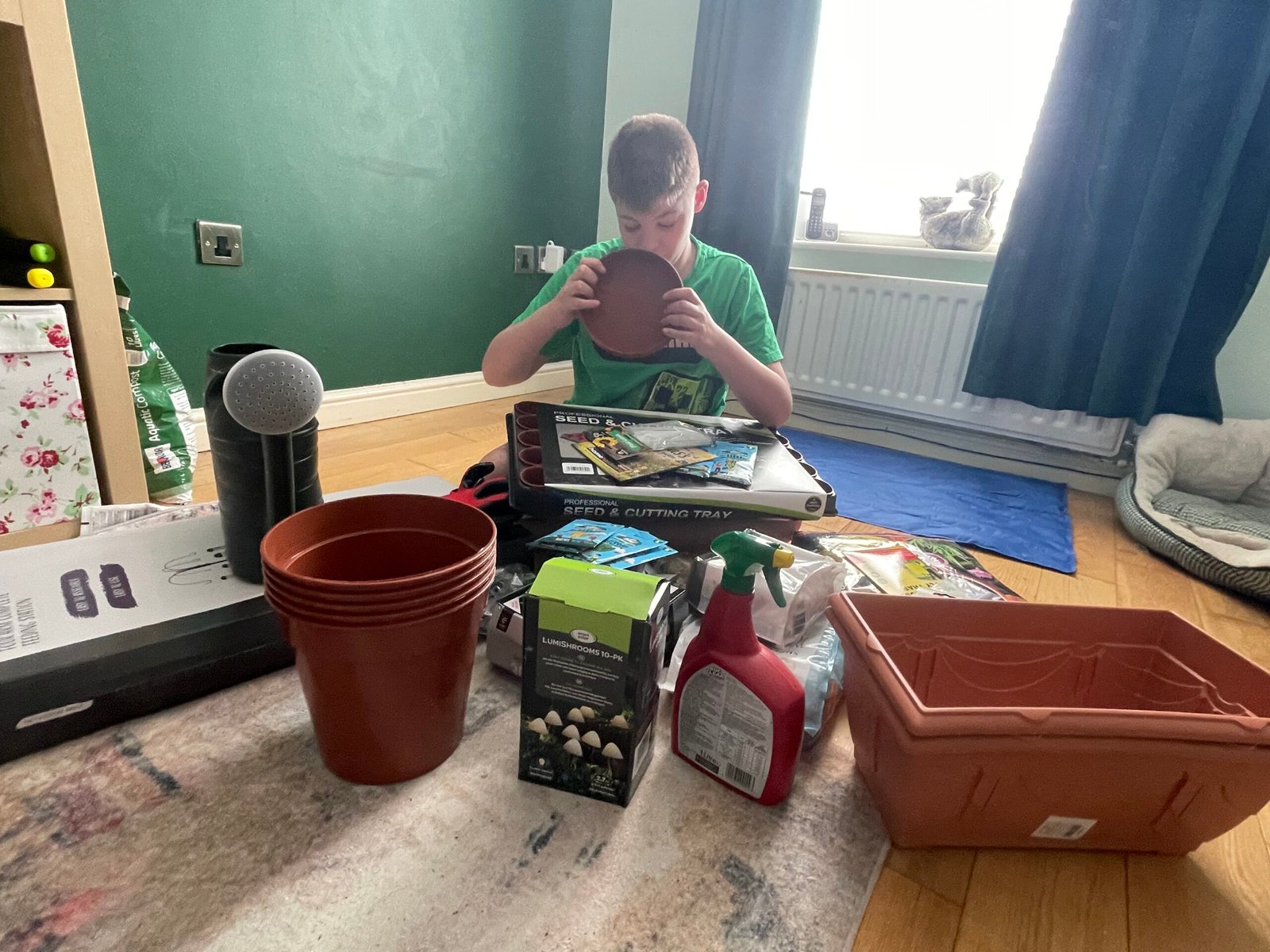Lucas exploring gardening donations including plant pots from Home Hardware Direct
