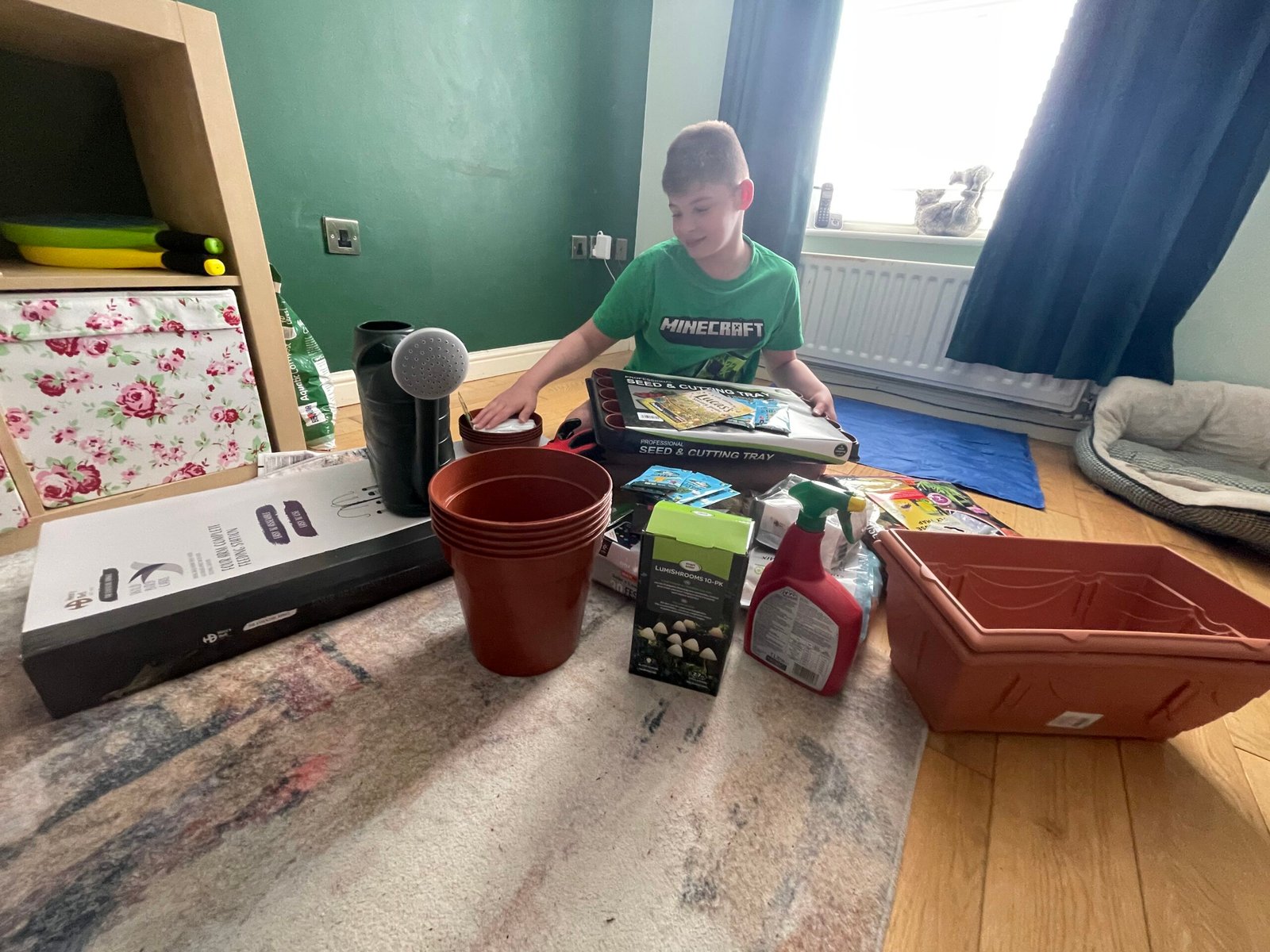 Lucas smiling with Pay It Forward gardening donations from Home Hardware Ayrshire